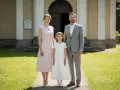 Rodzina w eleganckich strojach przed kościołem.